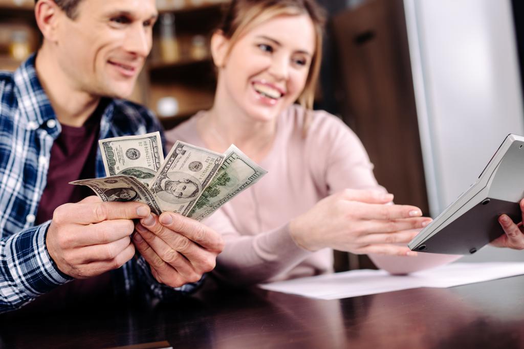 stock-photo-portrait-happy-couple-counting-money-together-home